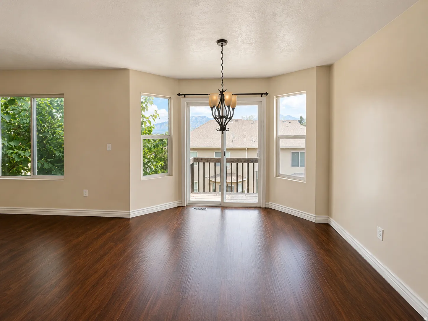Bay window featuring multiple large windows and a glass sliding door