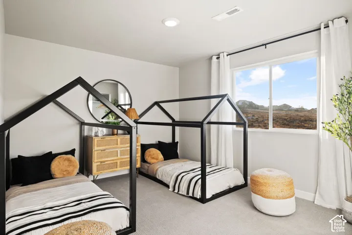 Neutral wall paint, recessed lighting, and a large window with white curtains