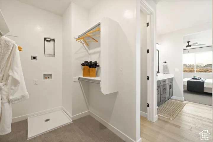 Laundry area with built-in shelving and hanging rod