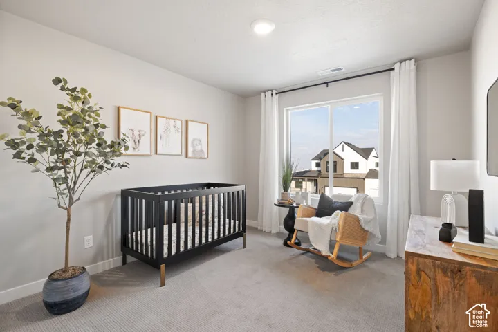 Recessed lighting, large window with surrounding drapery, light neutral wall color, and wall-to-wall carpeting