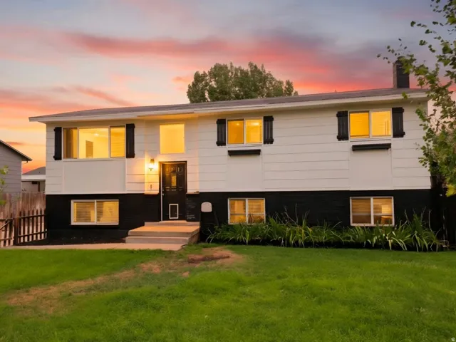 Two-tone exterior with white siding and a black lower level, featuring black decorative shutters