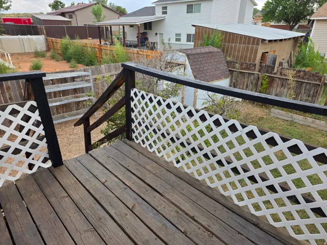 Expansive wood-plank deck with white lattice railing