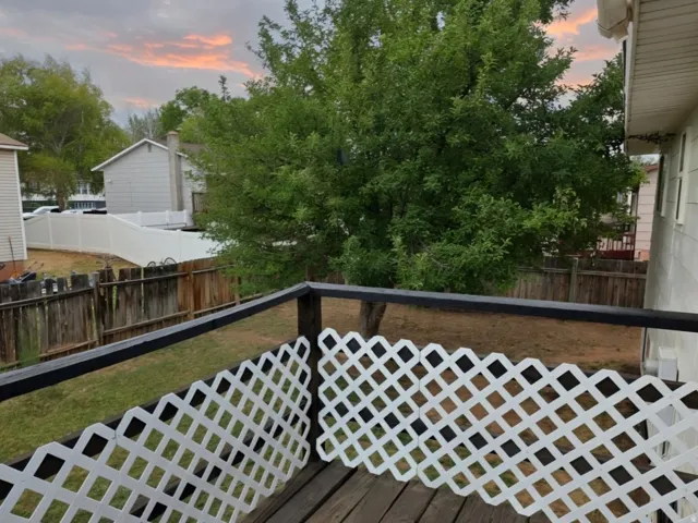 Wood-finish deck with white lattice railing