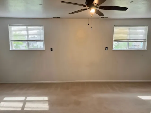 Bright, open room with dual windows flooding natural light throughout