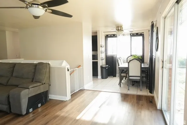 Wood-finish flooring throughout the main living area, leading to a tiled dining space