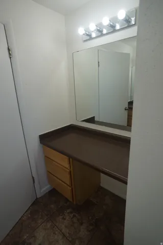 Built-in vanity with wood-finish drawer storage and a spacious countertop