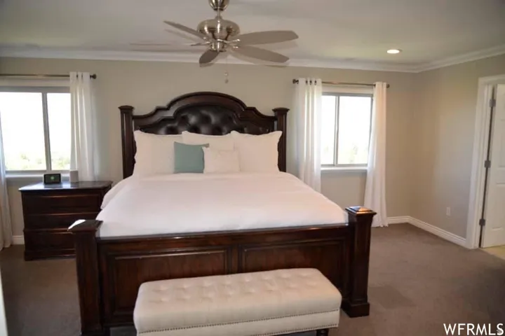 Recessed lighting, crown molding, ceiling fan, and carpet flooring