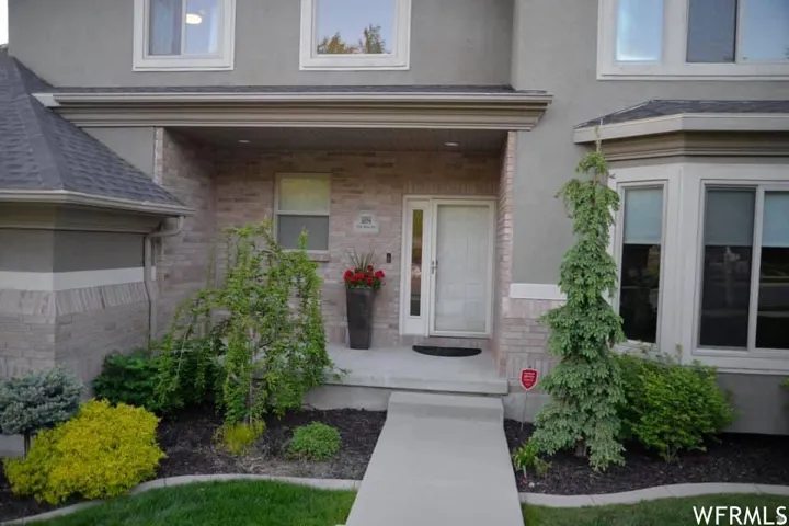 Stucco and brick exterior with a covered entry