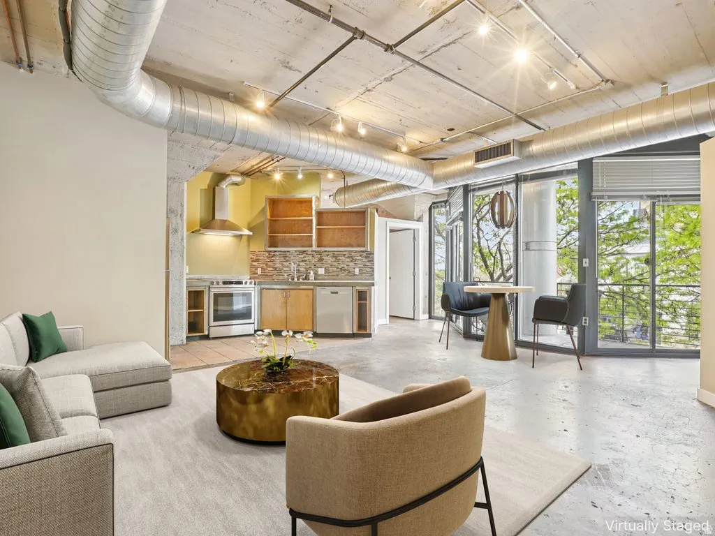 Exposed concrete ceilings with industrial ductwork and track lighting