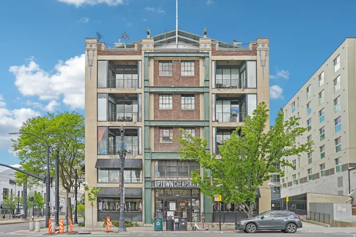 Mixed-material facade featuring brick and stucco elements