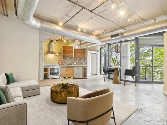 Exposed concrete ceilings with industrial ductwork and track lighting