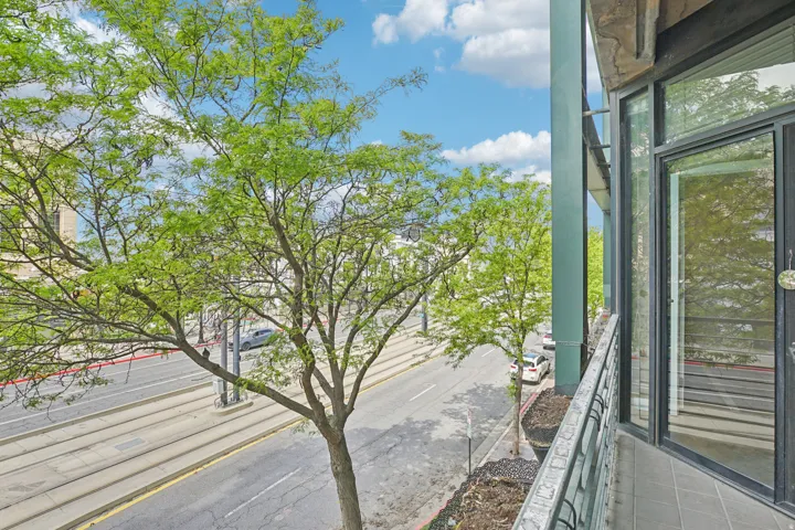 Balcony featuring tile flooring, metal railing, and glass sliding doors