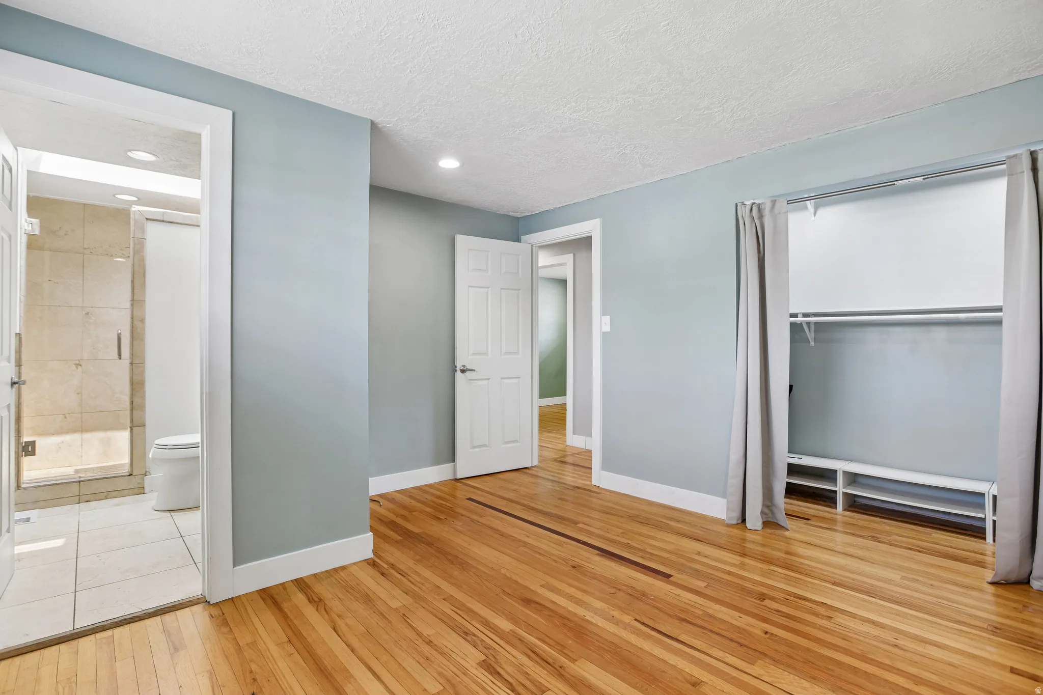 Hardwood flooring throughout, recessed lighting, and a built-in closet system