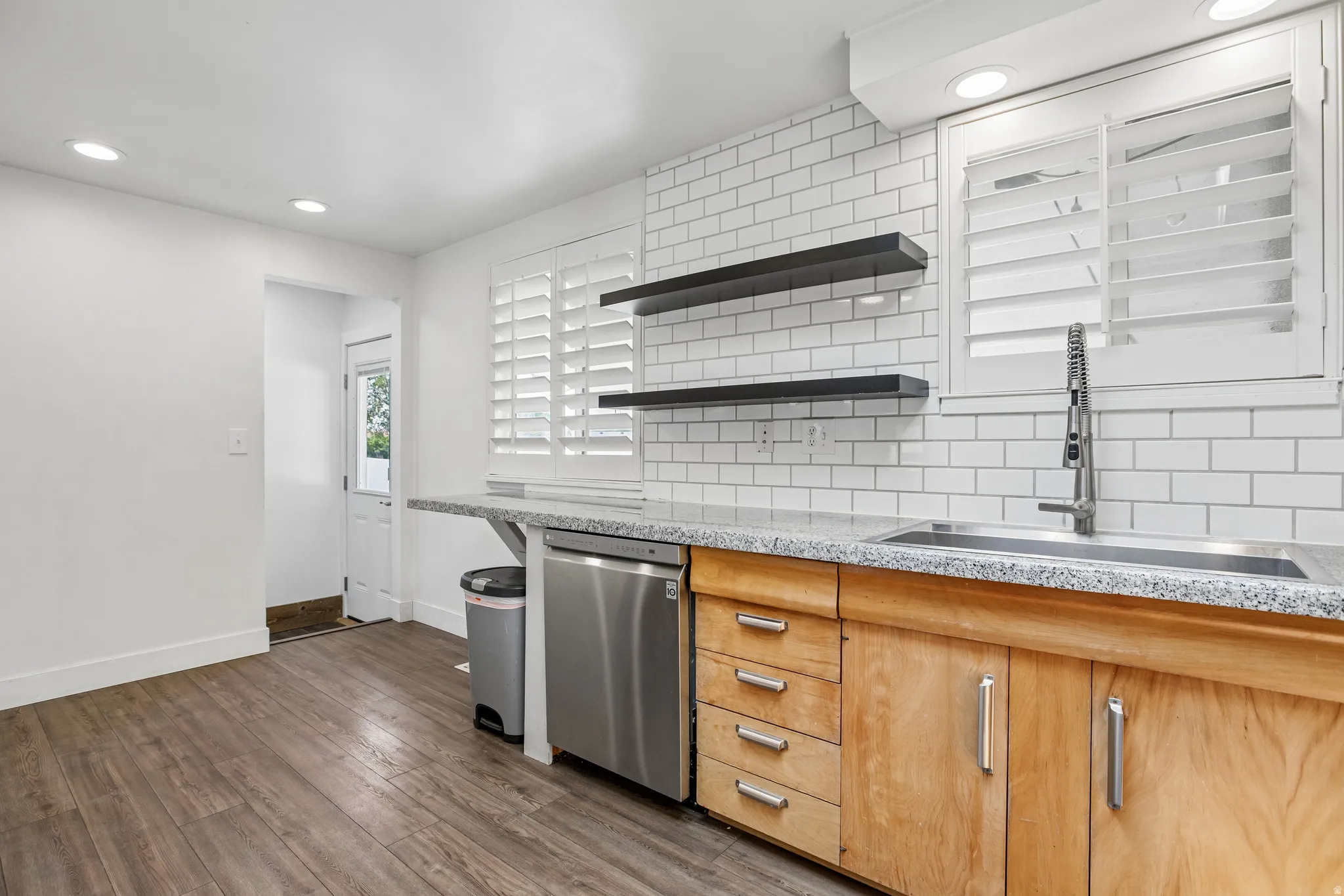 Wood-finish flooring throughout, complemented by recessed lighting