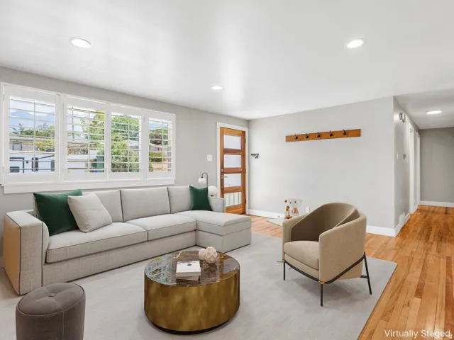 Recessed lighting, wood-finish flooring, white plantation shutters, and a wood-panel entry door