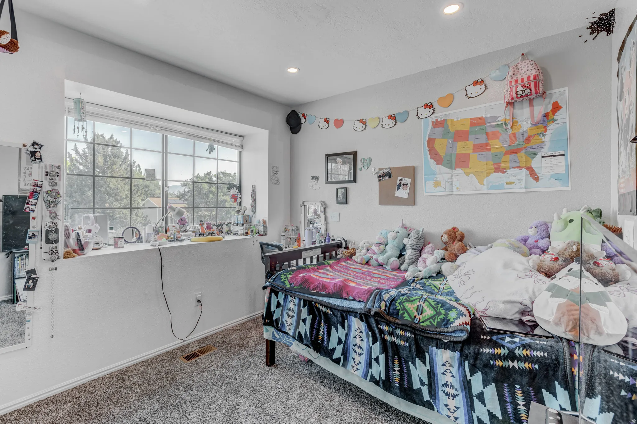 Recessed lighting, large window with deep sill, and neutral wall color