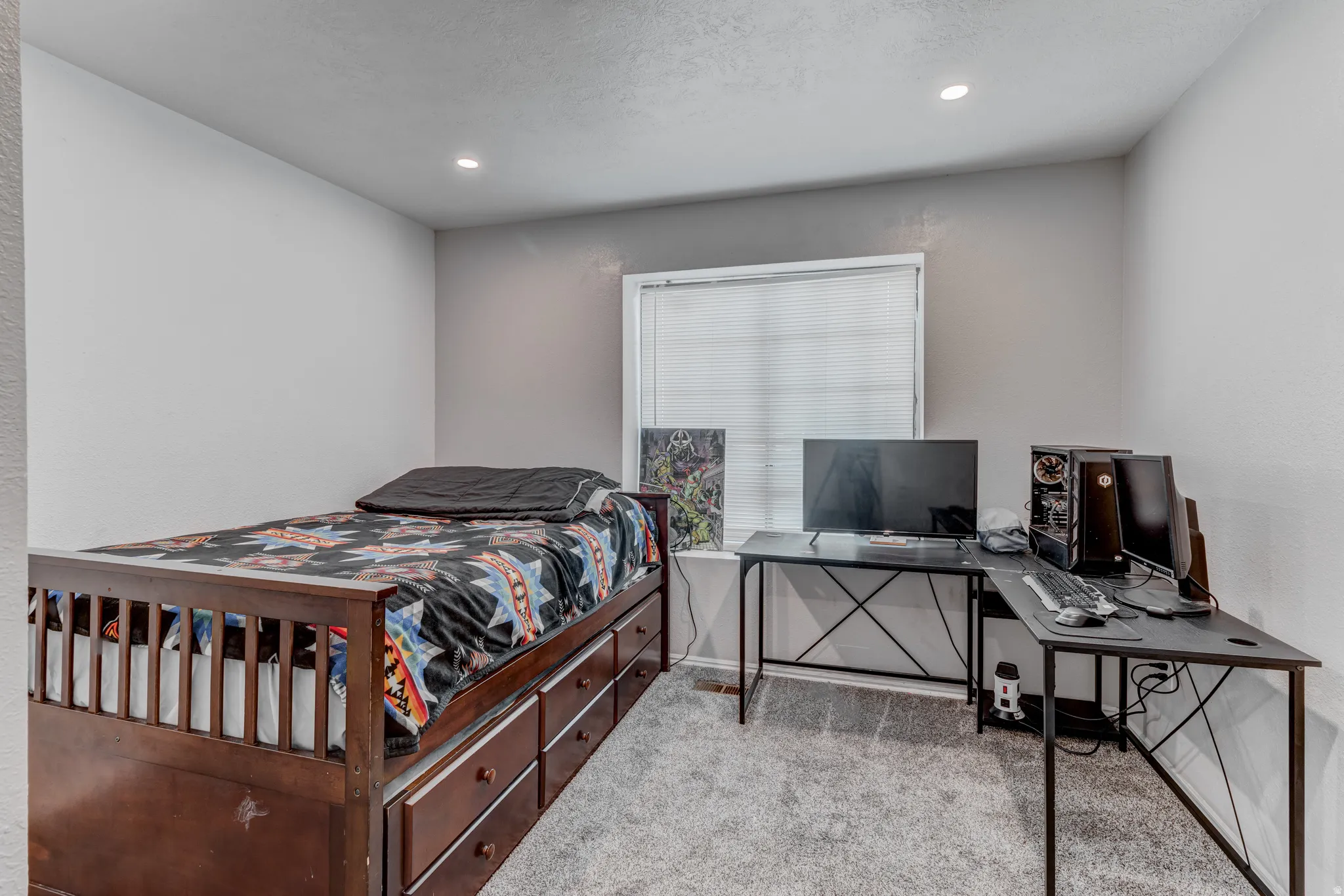 Recessed lighting, window with blinds, light gray wall finish, gray carpet flooring, wood-finish bed frame with built-in storage drawers
