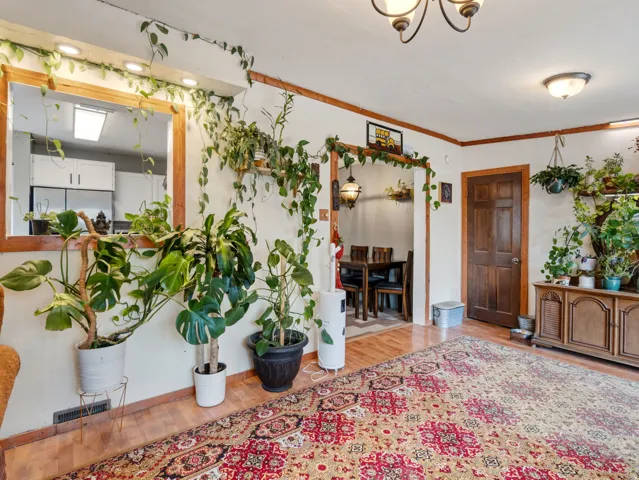 Hardwood-finish flooring, recessed lighting, and a wood-trimmed doorway
