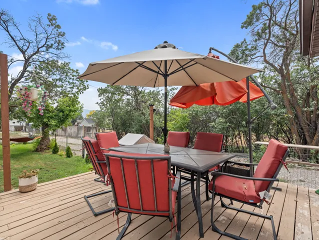 Expansive wood-finish deck with a metal railing