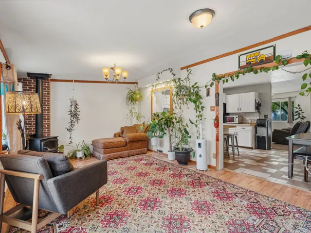 Wood-finish flooring with a brick-clad fireplace and wood-burning stove