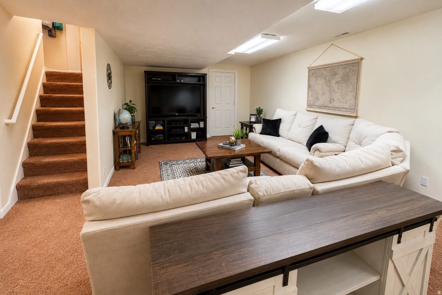 Finished lower level with carpeted flooring and stairway