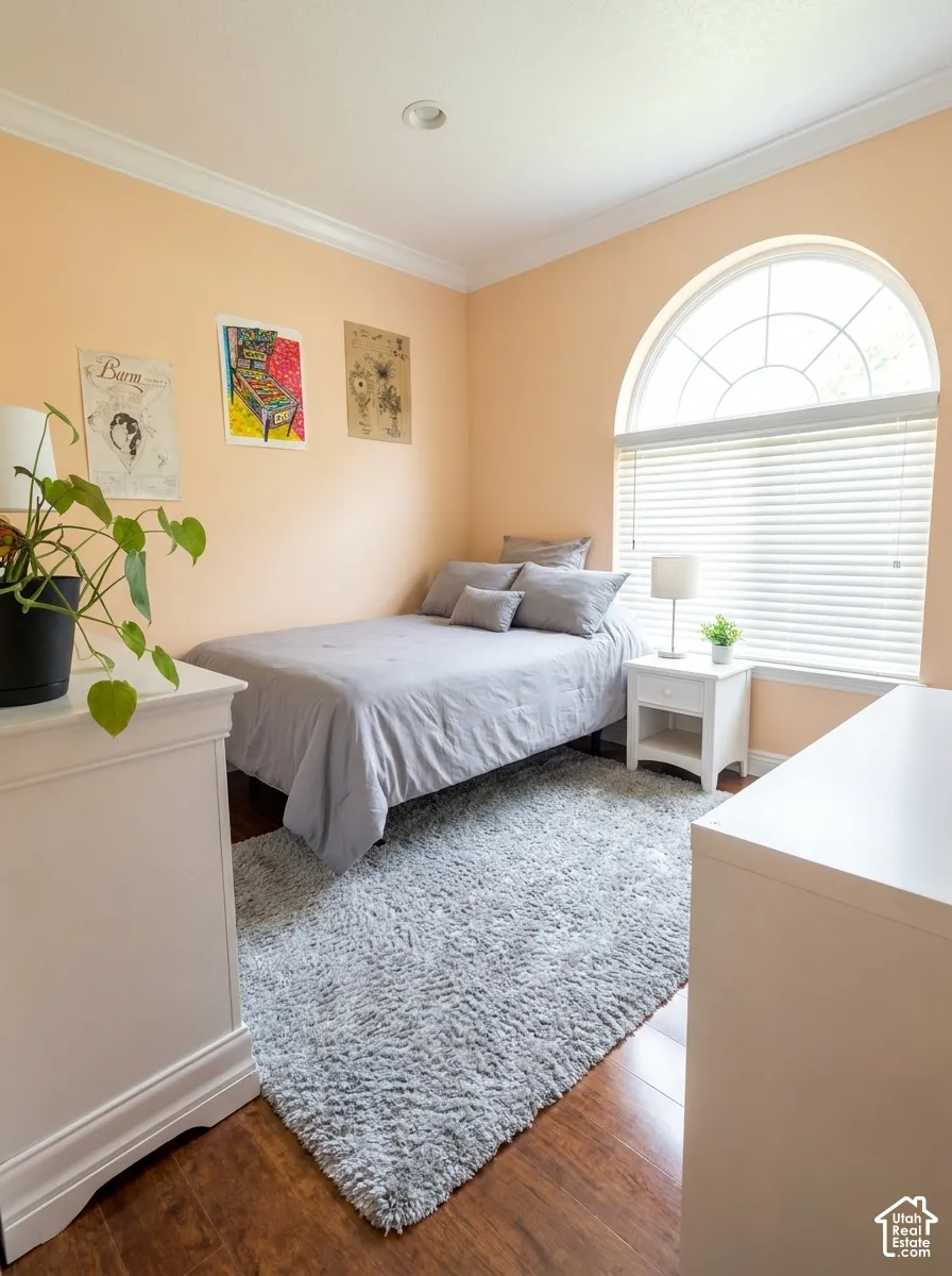 Wood-finish flooring with crown molding and recessed lighting