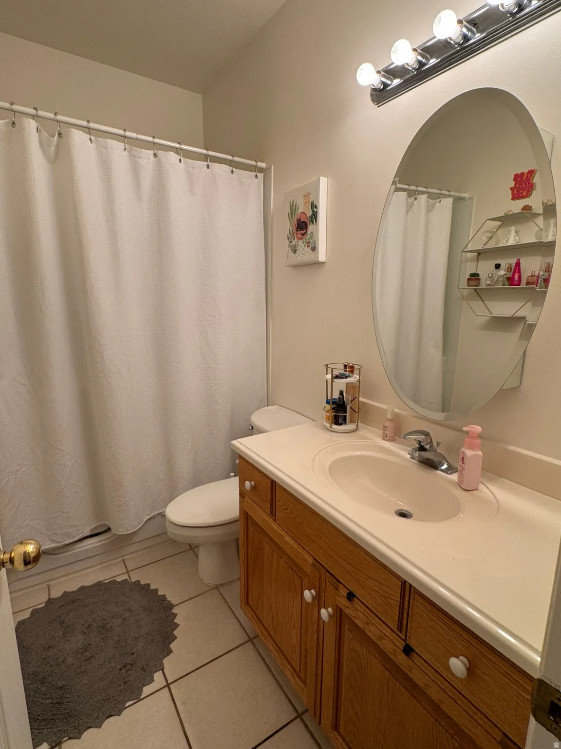 Built-in vanity with wood-finish cabinetry, integrated sink, and chrome-finish faucet