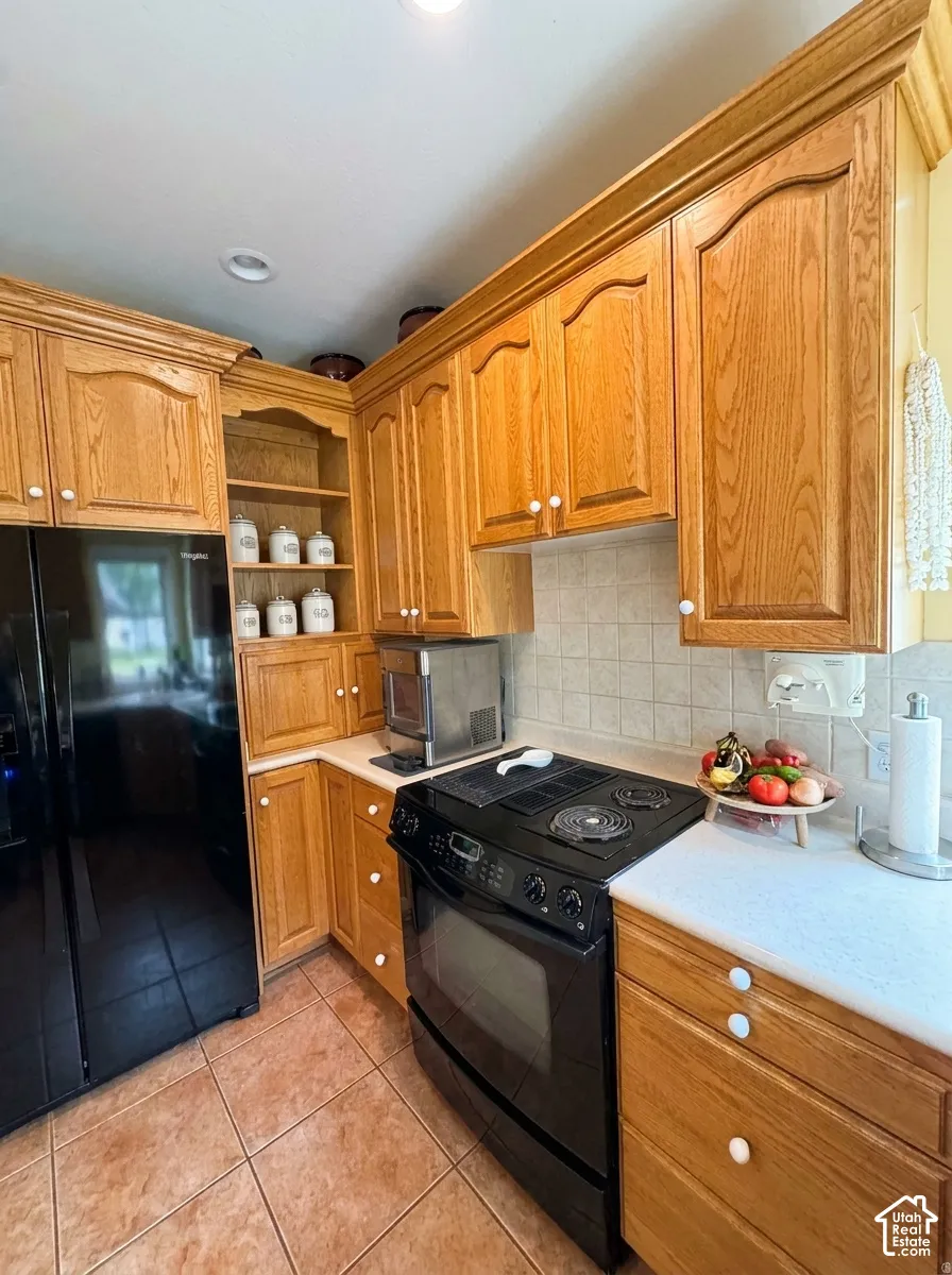 Wood-finish cabinetry with crown molding, integrated shelving, and white knob hardware