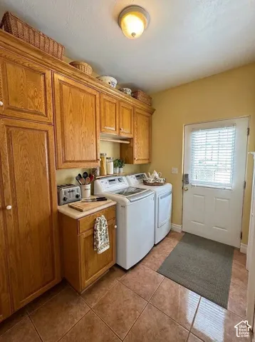 Extensive wood-finish cabinetry, tile flooring, and a solid surface countertop