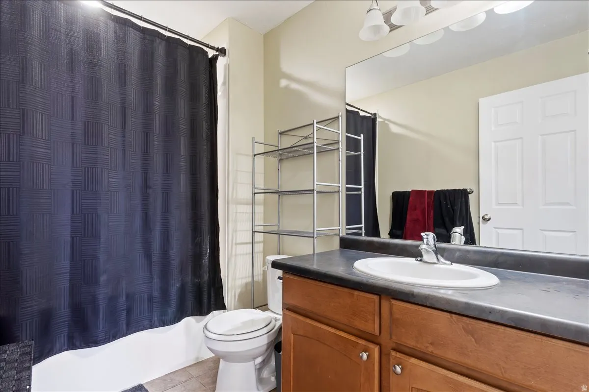 Vanity with wood-finish cabinetry, integrated sink, and extended countertop