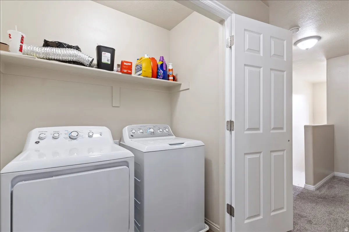 Laundry area featuring a built-in shelf, neutral wall tones, and overhead lighting