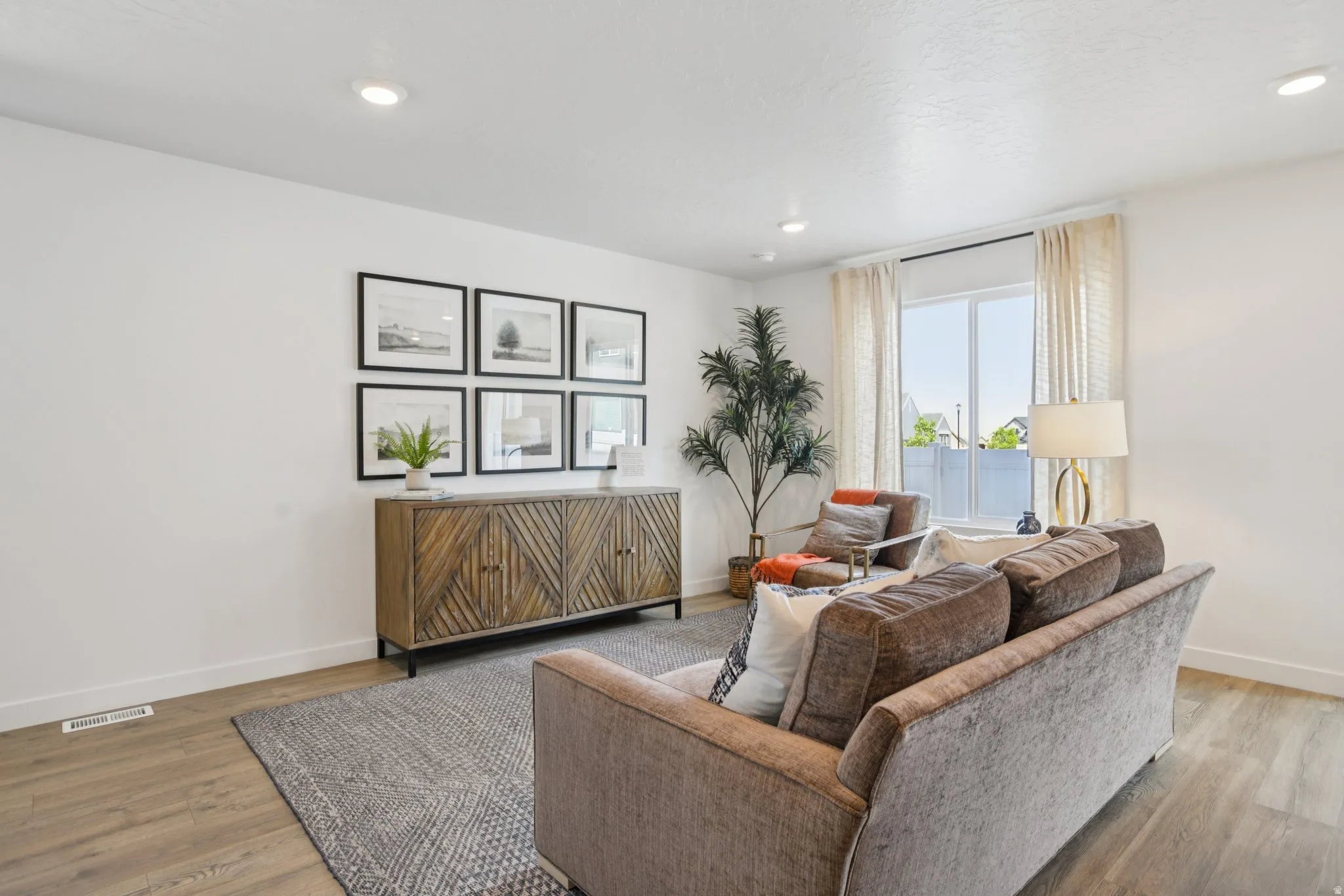 Recessed lighting throughout, wood-finish flooring, and white walls