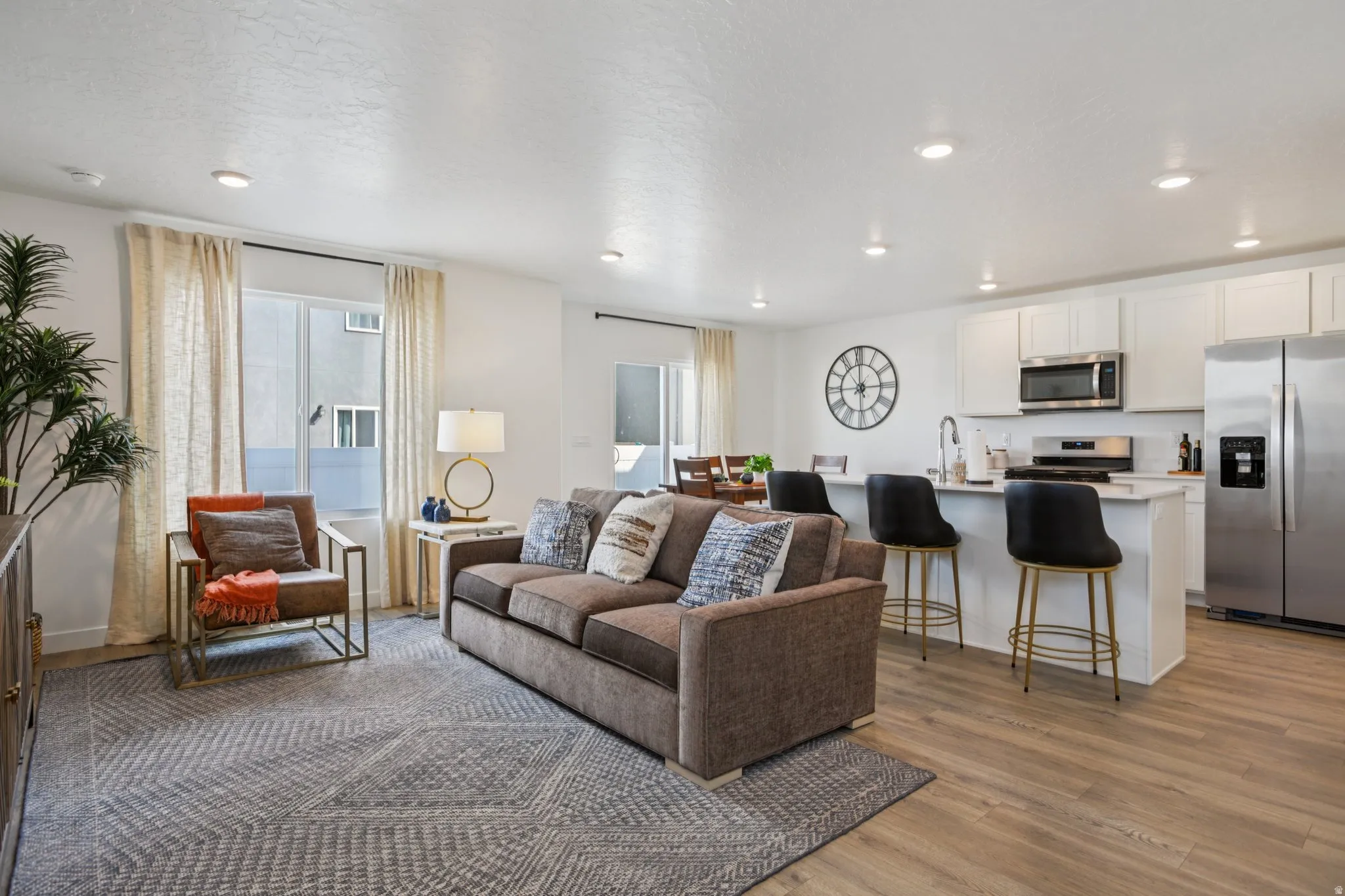 Open-concept living space featuring wood-finish flooring and recessed lighting