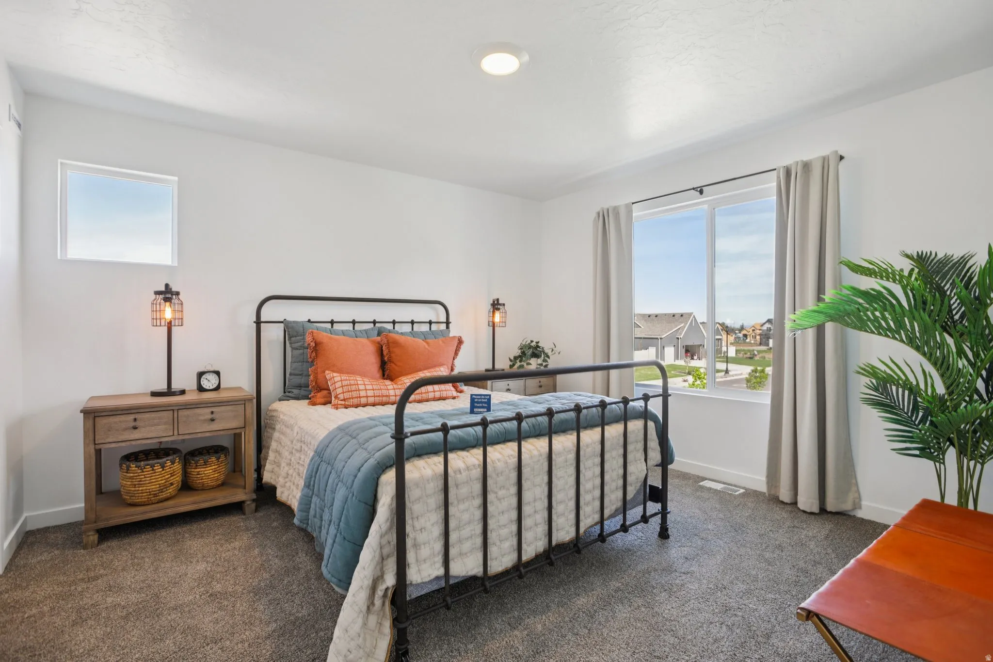 Expansive window, recessed ceiling lighting, light-toned walls, and carpet flooring