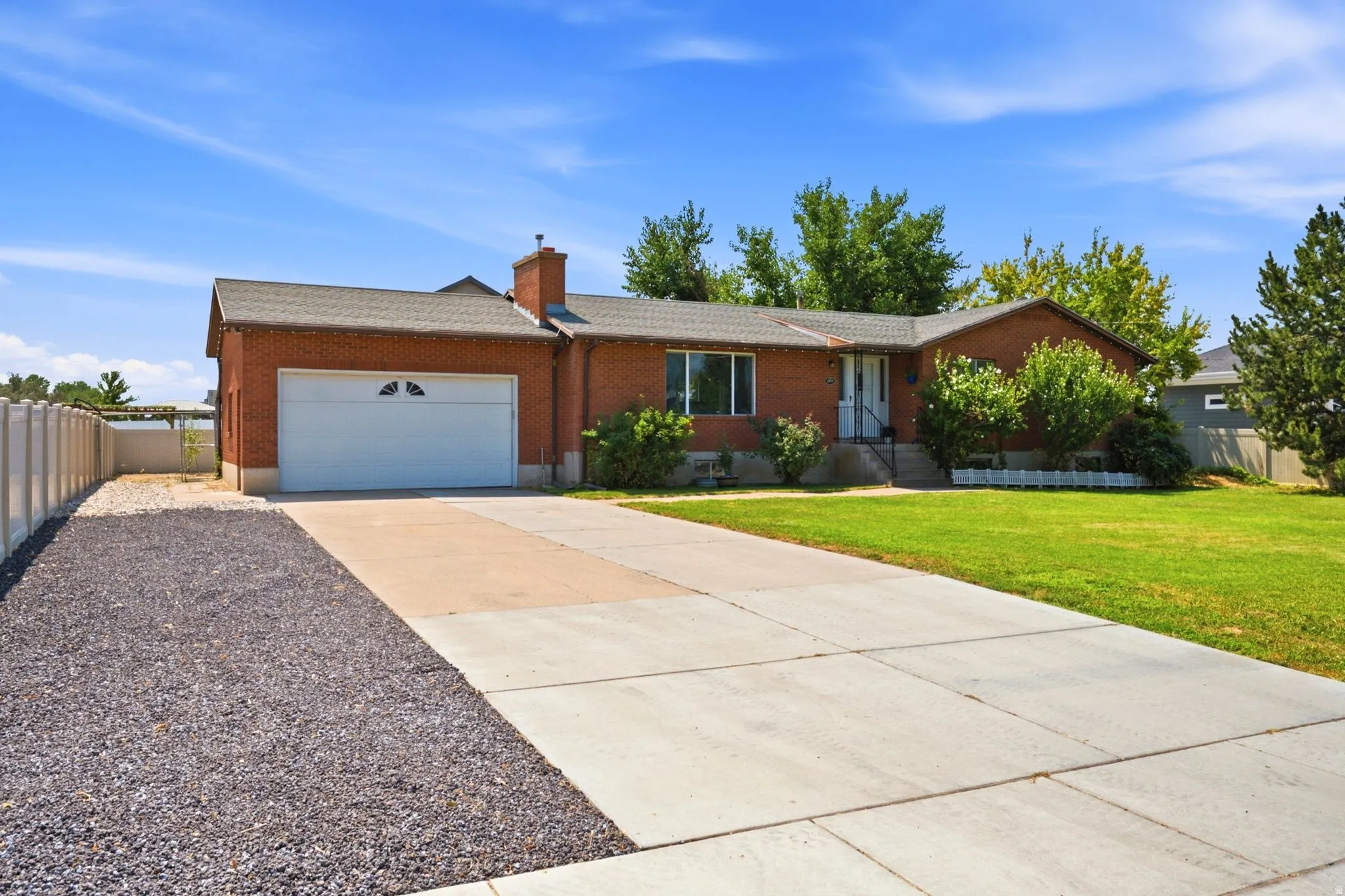 Brick exterior with a gabled roof and attached garage