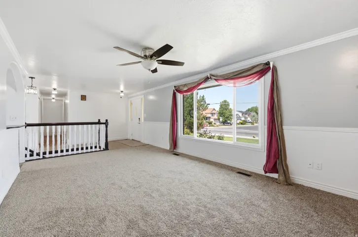 Open-concept area with light gray carpet and white walls