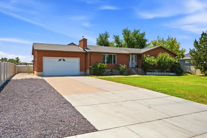 Brick exterior with a gabled roof and attached garage