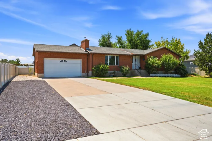 Brick exterior with a gabled roof and attached garage