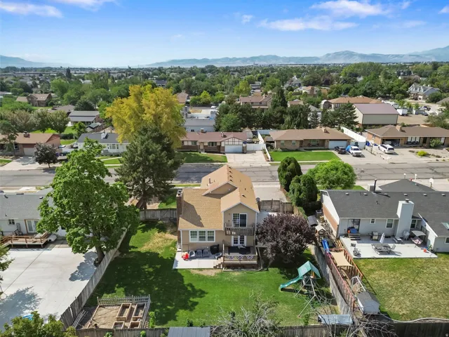 Two-story residence with a pitched roof, rear balcony, and lower-level patio