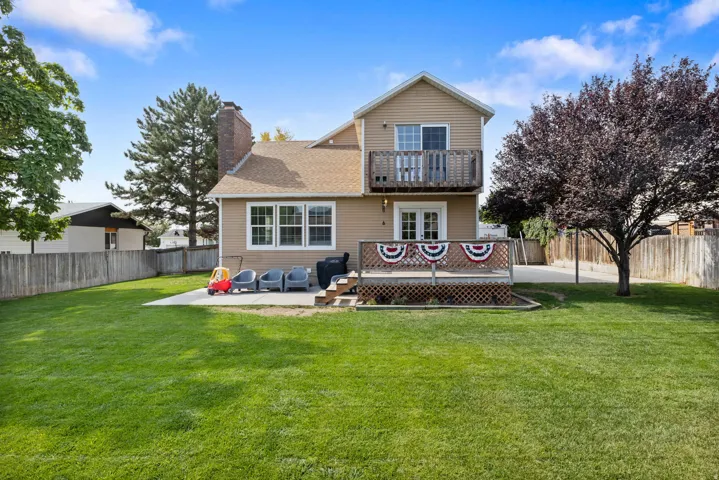 Expansive green lawn with a wood fence perimeter