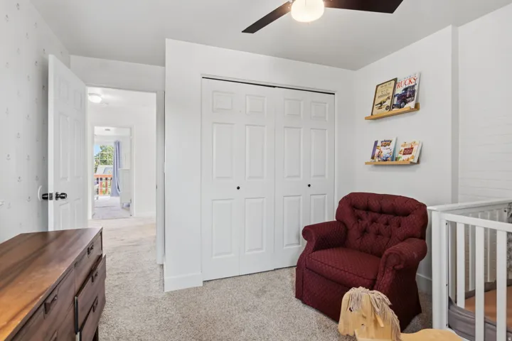Recessed lighting, wood-finish ceiling fan, wood-finish floating shelves, and paneled doors