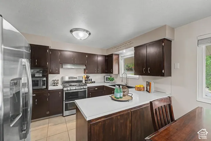 Espresso stained cabinets and new hardware nicely update the kitchen