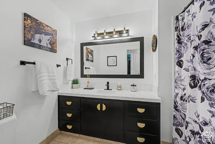 Main hall bath has been updated with modern hardware and fixtures and an espresso paint color on the cabinets.