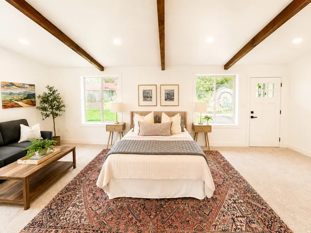 Room featuring exposed wood ceiling beams, recessed lighting, and carpet flooring