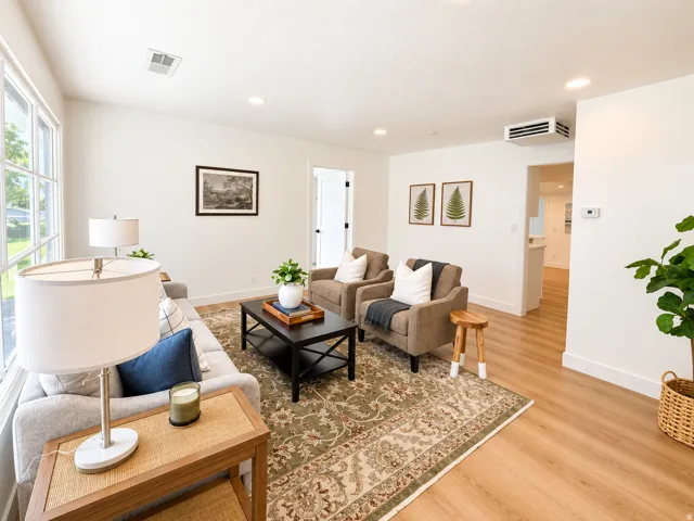 Recessed lighting, wood-finish flooring, white trim, and a window with multiple panes