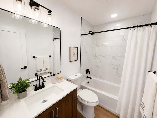 White vanity with a solid surface countertop and undermount sink