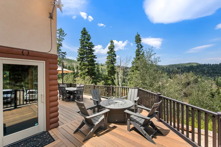 Expansive outdoor deck featuring wood-finish flooring and a wood railing system