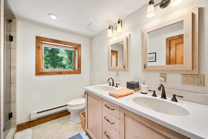 Dual vanity with integrated sinks and bronze-finish hardware