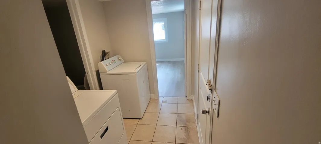 Tile flooring, neutral wall tones, interior door, and doorway to additional room