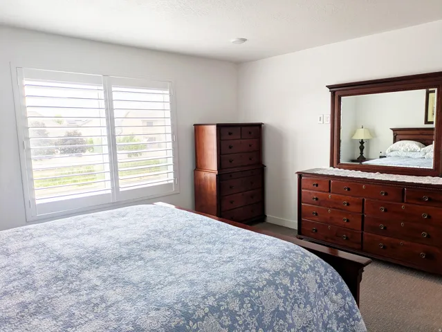 Window with white plantation shutters and overhead lighting